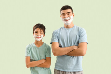 Poster - Man and his little son with shaving foam on faces against light color background