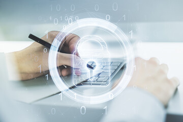 Poster - Double exposure of creative lock hologram with chip and hand writing in notebook on background with laptop. Information security concept