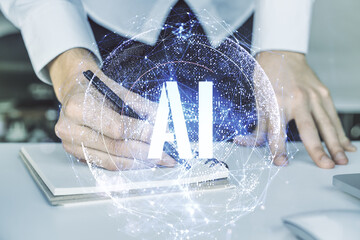 Poster - Creative artificial Intelligence symbol concept with hand writing in diary on background with laptop. Double exposure