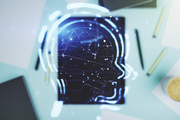 Poster - Creative artificial Intelligence concept with human head hologram and modern digital tablet on background, top view. Multiexposure