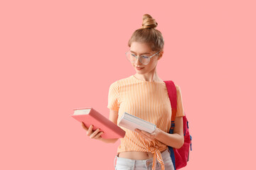 Canvas Print - Female student with books and backpack on pink background