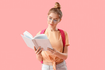 Canvas Print - Female student reading book on pink background