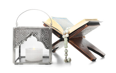 Wall Mural - Muslim lamp with burning candle and Koran on white background