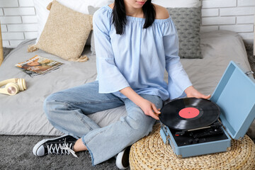 Canvas Print - Young woman with record player in bedroom