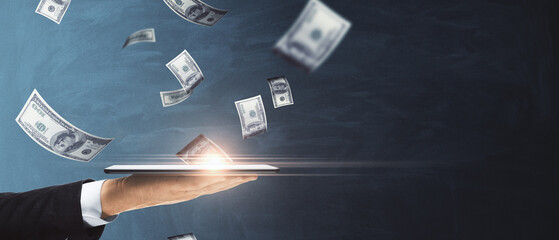 Poster - Close up of male hand holding cellphone with blurry flying dollar bills on chalkboard background with mock up place. Finance, success and casino concept.