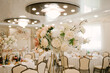 The large bright hall is decorated with flowers for the event, wedding decor