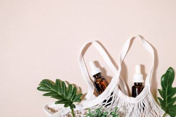 Wall Mural - two amber glasses bottle in the sustainable and eco friendly bag. organic, natural and clean beauty product. flatlay with copy space