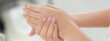 Closeup hands of woman applying moisturizer cream and lotion with hands for skin protection, skincare and cosmetic, treatment and bodycare for hygiene, touch hands with smooth, skin care concepts.