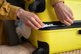 Fototapeta Zachód słońca - Preparation travel suitcase at home. Close up