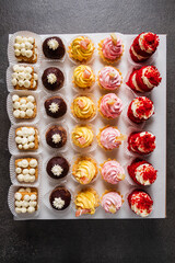 Sticker - Pastry shop display window with variety of mini desserts and cakes