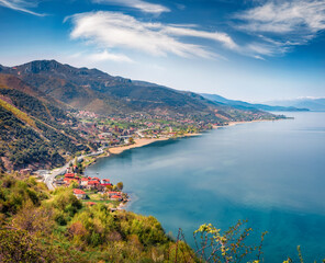 Wall Mural - Colorful spring cityscape of Pogradec town. Sunny morning scene of Ohrid lake. Breathtaking landscape of Albania, Europe. Beauty of nature concept background.
