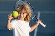 © Volodymyr - Tennis kid. Child with tennis racket and tennis ball playing on tennis court.