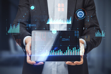 Poster - Close up of businessman hands holding tablet with glowing digital business interface with charts on blurry office interior background. Infographic and big data concept. Double exposure.