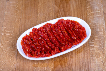 Chili paste. Hot snack prepared with pepper paste in a ceramic bowl. close up