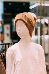 Wall Mural - Casual warm Hat On Mannequin In Store Of Shopping Center. shelf display in shop mall store. Store Of Shopping Center. retail sale.