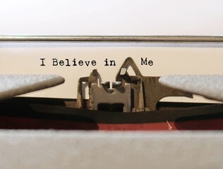 Old vintage typewriter with text typed I BELIEVE IN ME, concept of positive self talk or affirmation to boost self esteem, affirming one own worthiness and value
