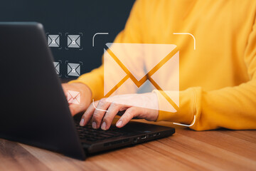 Poster - Concept of Email marketing, send e-mail or news letter, online working internet network. Man hand using computer laptop typing on keyboard and surfing the internet on office table with email icon.