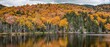 Panoramic shot of a pond reflecting an autumn forest, New Hampshire, USA