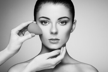 Wall Mural - makeup artist applies skintone. beautiful woman face. perfect makeup. skincare foundation. sponge ma