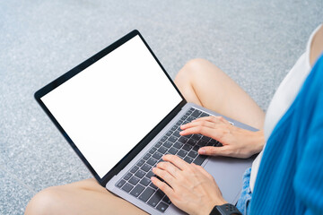 Fototapete - Woman hand type on the keyboard on laptop with mockup of blank screen for the application.