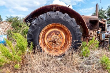 Sticker - Rusty remains of an agricultural machine outdoors