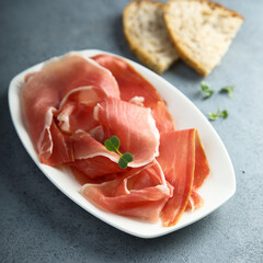 Wall Mural - Delicious cured meat on a white plate 