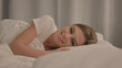 © stockbakers - Side View of Smiling Young Woman Lying in Bed