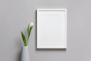 Wall Mural - Blank vertical frame mockup with fresh tulip flower in vase, white mock up with copy space