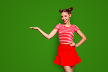 Sticker - Recommend advertising concept. Portrait of young cute brunette lady holding and demonstrate invisible product on hand isolated on red background with copyspace