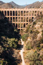 Old Aqueduct Arch Over A Dried Up River Near The Spanish City Of Nerja