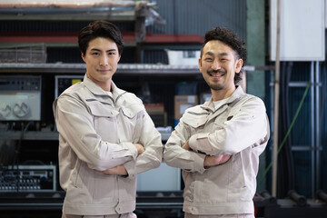 two cool workers at a factory looking at the camera