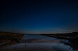 A moonlit view of the night sky over the beach at Beadnell , Northumberland in the United Kingdom