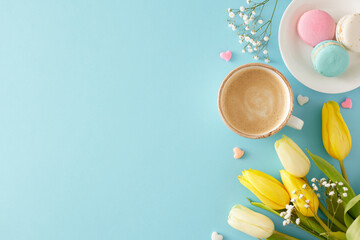 Wall Mural - Mother's Day concept. Top view photo of cup of coffee plate with macaroons small hearts yellow white tulips and gypsophila flowers on pastel blue background with blank space