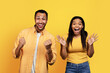 © Prostock-studio - Glad millennial african american husband and wife celebrating victory, making success sign with hands