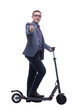 © ASDF - Pleasant smiling man riding a kick scooter