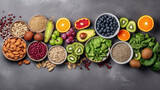 Fototapeta Mapy - Healthy food selection: fruit, seeds, superfood, cereal, leaf vegetable on gray concrete background, top view
