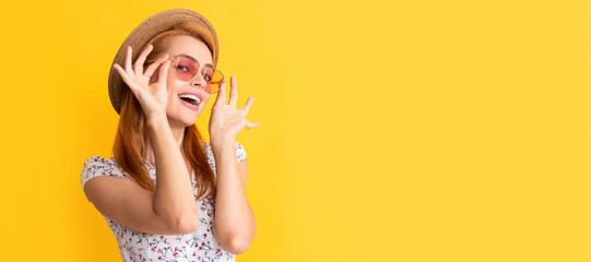 Poster - Woman isolated face portrait, banner with copy space background. glad young woman in straw hat and sunglasses on yellow background.