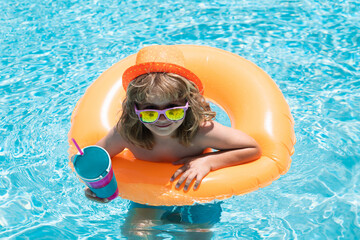 Boy swimming and playing in a pool. Child playing in swim pool. Summer vacation concept. Summer kids portrait.