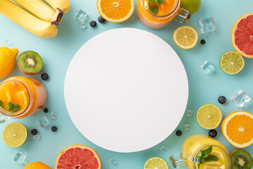 Get a taste of summer with stylish top view flat lay of citrus juices and cocktails featuring oranges, lemons, limes, and grapefruits on a trendy paste blue background with an empty circle for text