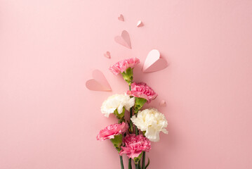 Wall Mural - Mother's Day present idea. Top view of carnation flowers and heart-shaped papers on a pastel pink surface