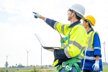 Wall Mural - Engineer working at windmill farm,Generating electricity clean energy.