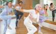 © JackF - Dynamic elderly woman attendee of dance studio dancing hip-hop during training session. Women training dance in hall
