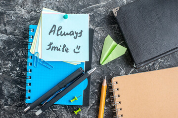 top view always smile note with pens and copybook on the gray background study note college school n