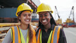 © Andy Dean - Two Smiling Young Adult Multiethnic Female Workers Wearing Hard Hat and Safety Vest Standing at a Shipping Dock - Generative AI.