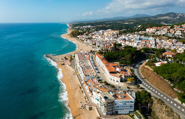 Wall Mural - Birds eye view of Sant Pol de Mar, Spain. Residential building along Mediterranean sea coast and beach visible from above.