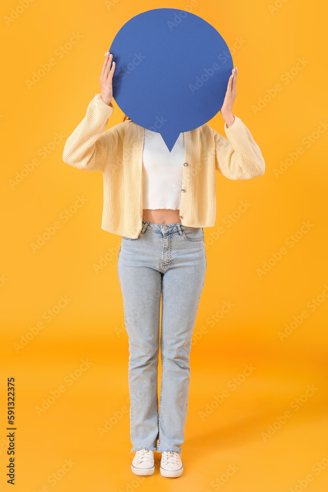 Young woman with blank speech bubble on yellow background
