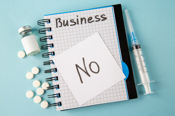 Wall Mural - top view open copybook with no note pills and injection on blue background color school college viru