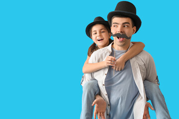 Poster - Portrait of father and his little daughter with paper mustache on light blue background