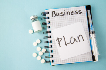Wall Mural - top view open copybook with plan note pills and injection on a blue background color school college 