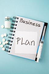 Wall Mural - top view open copybook with plan note pills and injection on the blue background color school colleg